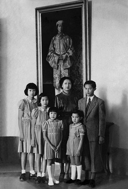 Photo  34. L'impératrice Nam Phương et ses enfants devant le portrait de Bảo Đại